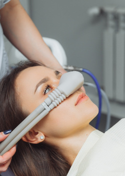 A woman receiving nitrous oxide sedation