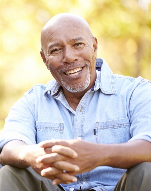 Man smiling after periodontal visit using sedation dentistry