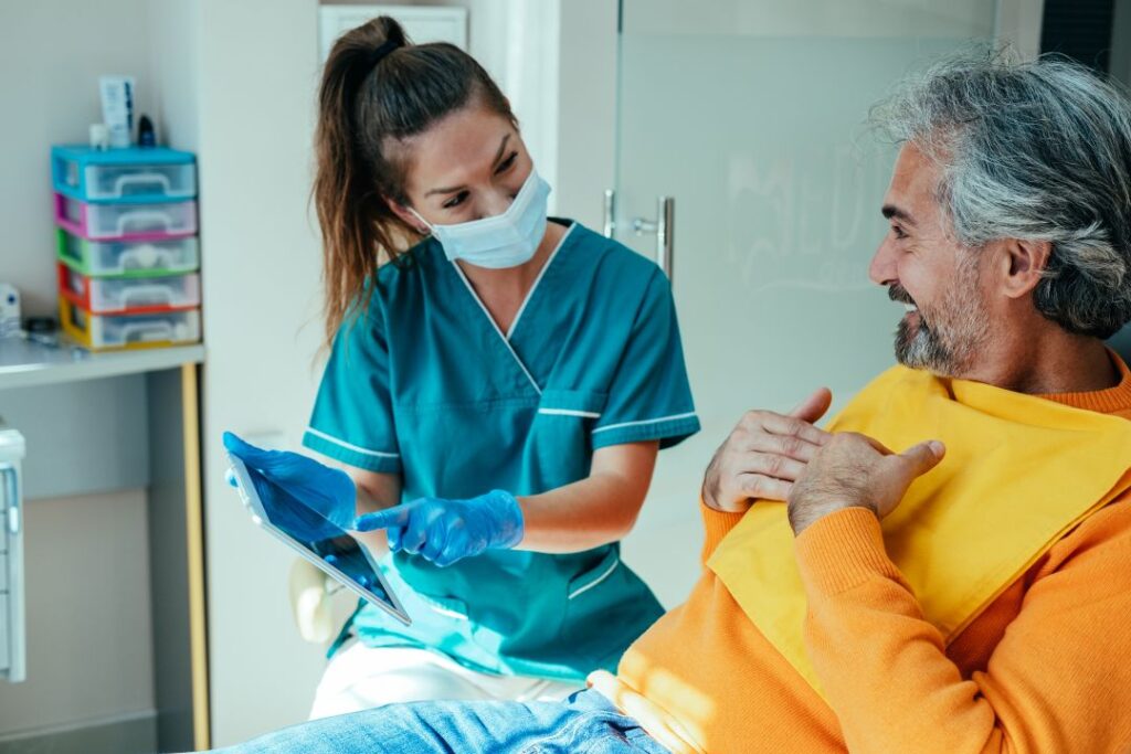 A man talking to a dentist