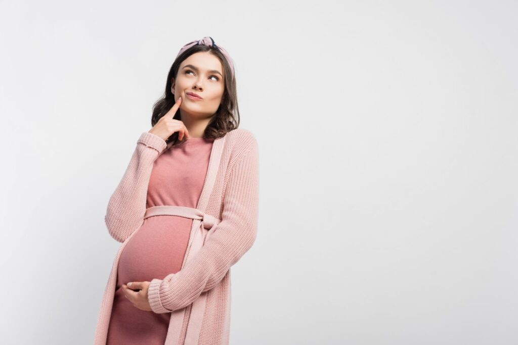 A pregnant woman pondering