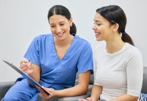 Dental staff member talking to patient about dental insurance